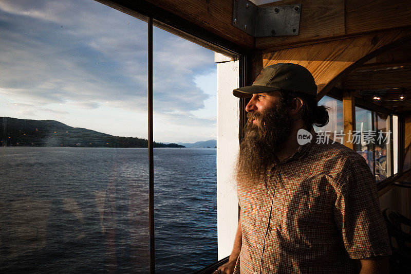 Long Hair Bearded Sailor Man on Wooden Boat